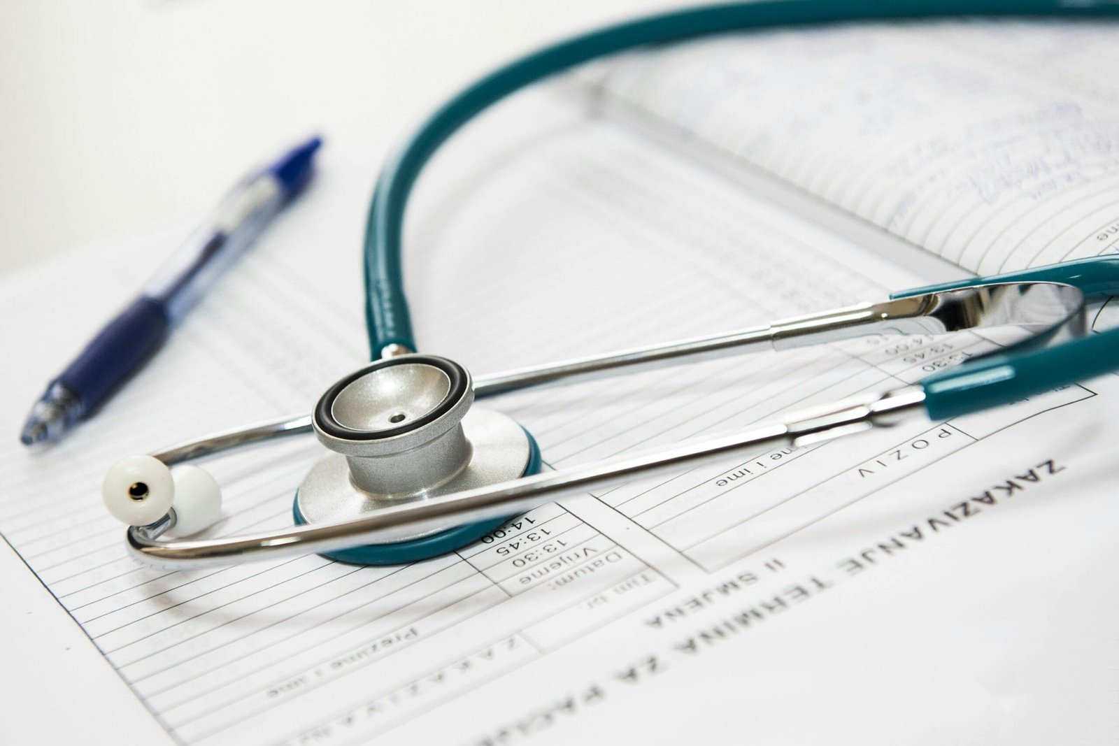 Imagen de estetoscopio verde junto a documentos médicos. Estetoscopio y bolígrafo azul
sobre registros médicos. Equipo médico. Estetoscopio en consultorio médico. Fotografía de
estetoscopio en el hospital. Estetoscopio verde sobre registros médicos.