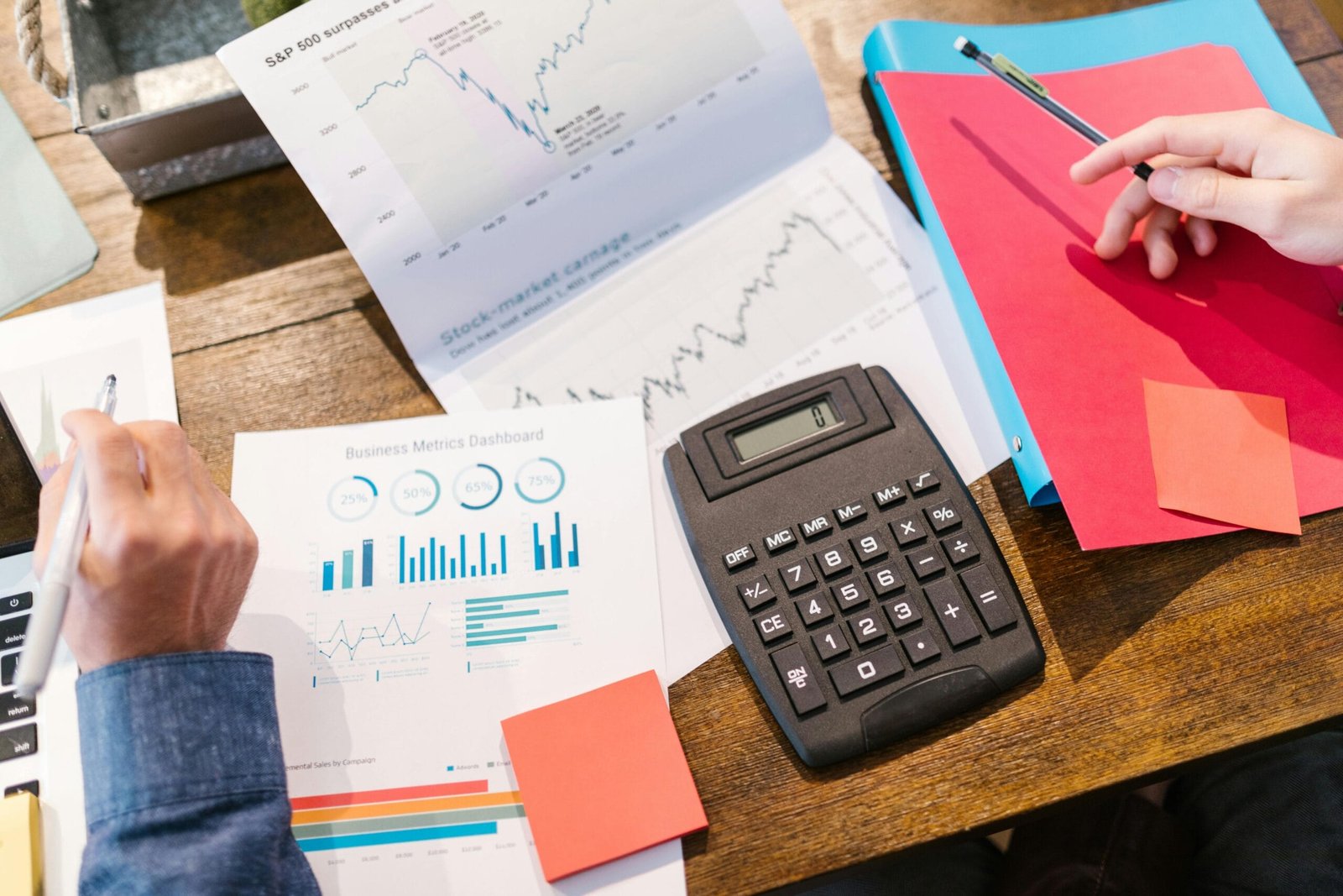 Reportes de estadística en los que se pueden observar algunas gráficas y tablas siendo interpretados por especialistas en el área de económico administrativo, donde se muestran datos relevantes para una empresa y son un factor para la toma de decisiones de dicha empresa, también se muestran algunas herramientas como una calculadora y laptop que son utilizados para esta área.